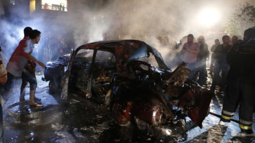 People gather at the site of an explosion at the southern suburbs of the Lebanese capital Beirut June 23, 2014. An explosion shook the southern suburbs of the Lebanese capital Beirut on Monday night, residents said. REUTERS/Mohamed Azakir (LEBANON - Tags: POLITICS CIVIL UNREST TPX IMAGES OF THE DAY) - RTR3VCRK