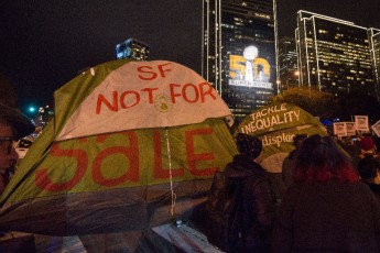 Protesters were flanked by police in riot gear as they marched past "Super Bowl City" in Downtown San Fransisco. The protest was in opposition to Mayor Ed Lee's removal of homeless people for this weekend's super bowl activities. 
