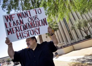 Carlos Galindo protests Monday, May 9, 2011 outside the Arizona Department of Education in Phoenix, along with other supporters of an ethnic studies program in the Tucson Unified School District. About a dozen people showed up Monday and held signs accusing the department of a policy of attacking Arizona Latinos after former school's chief Tom Horne declared the program a violation of state law and called for its elimination hours before his term ended and he became Arizona Attorney General. (AP Photo/Matt York)