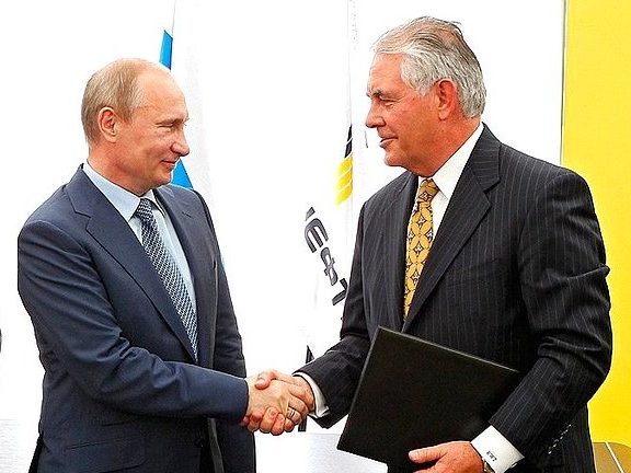 Vladimir Putin shakes hands with President and Chairman of ExxonMobil Rex Tillerson over joint development of difficult-to-access reserves in western Siberia in June 2012.