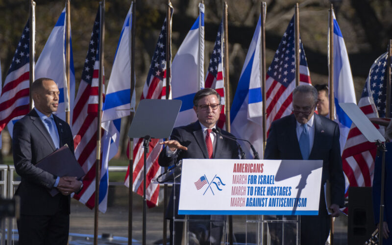 House Speaker Mike Johnson, of La., with House Minority Leader Hakeem Jeffries, D-N.Y., and Senate Majority Leader Chuck Schumer of N.Y., speaks during a March for Israel rally on the National Mall in Washington, Tuesday, Nov. 14, 2023. (AP Photo/Manuel Balce Ceneta)
