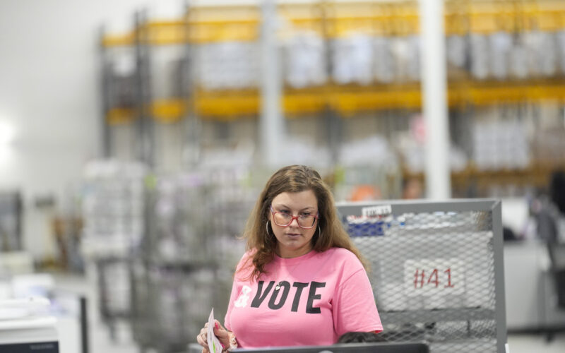 A worker inspects ballots at a ballot processing center Tuesday, March 5, 2024, in the City of Industry, Calif. (AP Photo/Marcio Jose Sanchez)
