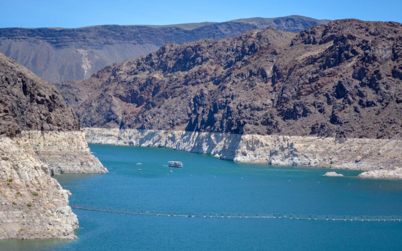 Low water levels are apparent on a bright blue lake.