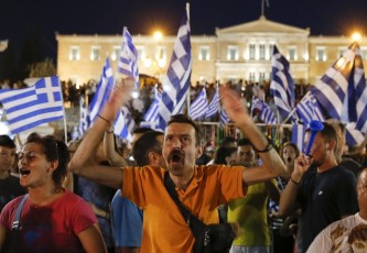 Greek No supporters celebrate the initial exit poll results from the referendum that placed No at 61.3% of the vote and and Yes at 38.6%