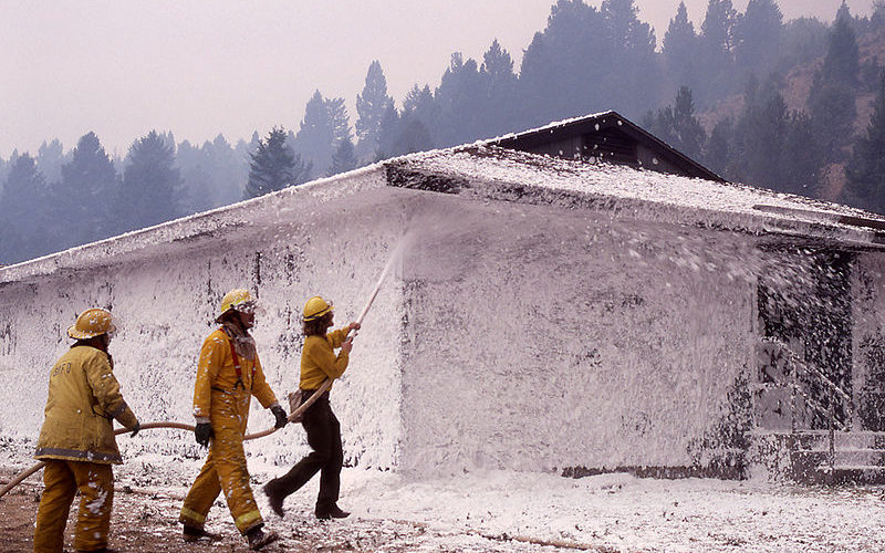 Firefighter using foam to put out a fire