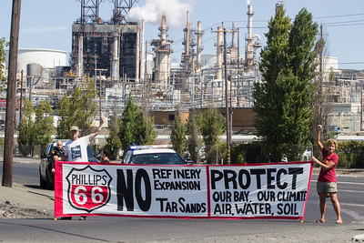 Protestors hold in front of the Phillips 66 refinery in rodeo