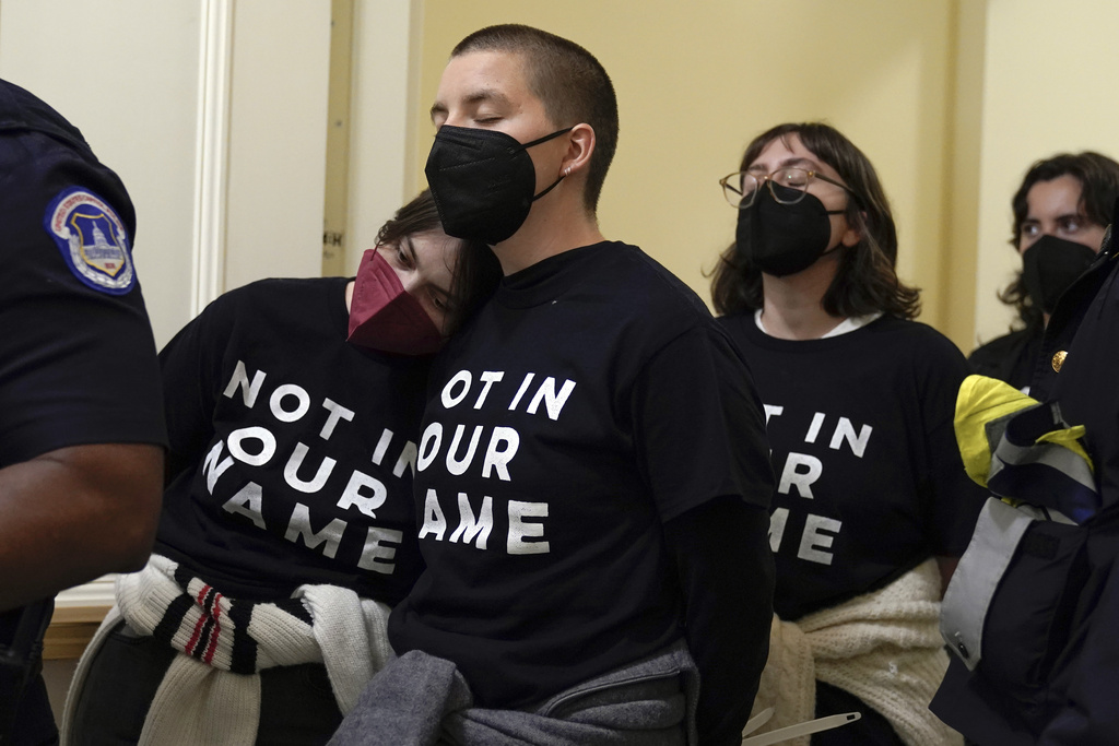 Demonstrators protest inside the Cannon House Office Building on Capitol Hill in Washington, Wednesday, Oct. 18, 2023. (AP Photo/Mariam Zuhaib)