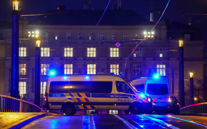 Police officers in a van secure the area in downtown Prague, Czech Republic, Thursday, Dec. 21, 2023. Czech police say a shooting in downtown Prague has killed an unspecified number of people and wounded others. (AP Photo/Petr David Josek)