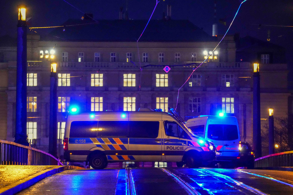 Police officers in a van secure the area in downtown Prague, Czech Republic, Thursday, Dec. 21, 2023. Czech police say a shooting in downtown Prague has killed an unspecified number of people and wounded others. (AP Photo/Petr David Josek)