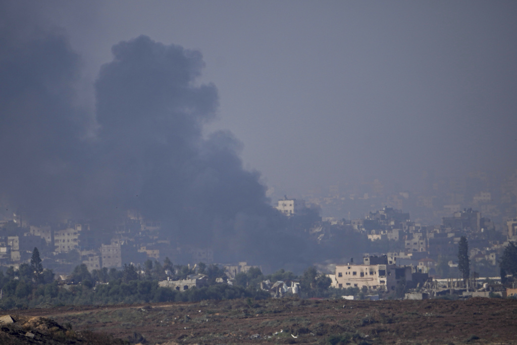 Smoke rises following an Israeli airstrike in the Gaza Strip, as seen from southern Israel, Friday, Dec. 1, 2023. (AP Photo/Ariel Schalit)