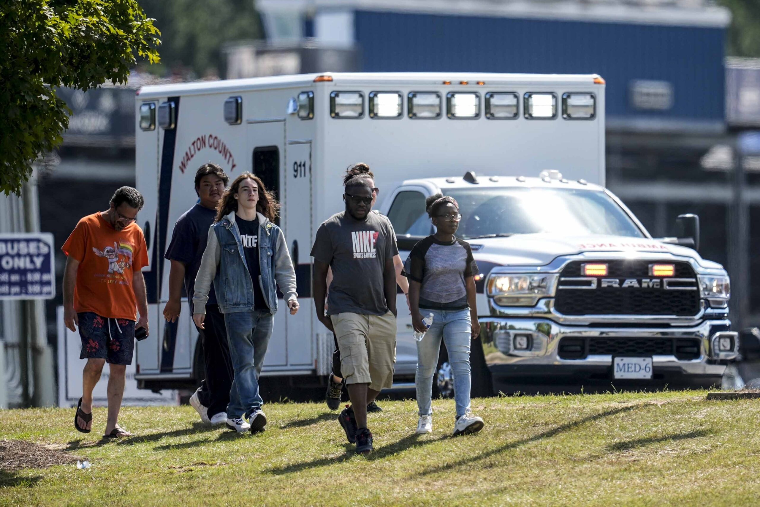 Students and parents walk off campus at Apalachee High School, Wednesday, Sept. 4, 2024, in Winder, Ga. (AP Photo/Mike Stewart)