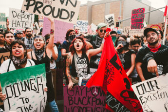 Protesters holding banners and protest signs at an anti-Trump rally in Los Angeles in 2016, when he was first elected president. 